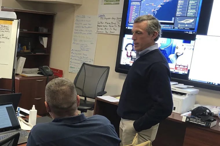 Delaware Gov. John Carney meets with staffers during a tour of the State Health Operations Center. Carney announced some small businesses would be allowed to reopen on Friday, May 8.