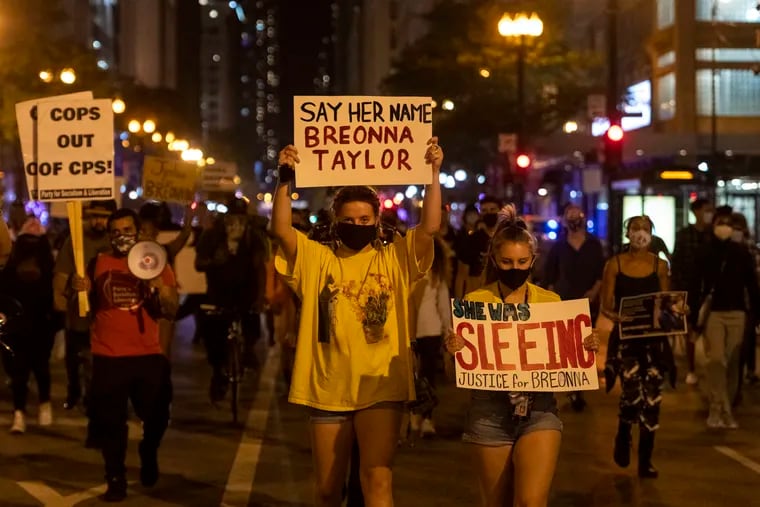 A couple hundred march on State Street in Chicago's Loop neighborhood, during protests in Chicago demanding justice for Breonna Taylor, Wednesday, Sept. 23, 2020.