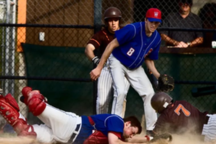 Mike Giuliano scores the winning run in the bottom of the sixth inning, beating the tag of Washington Township catcher T.J. Alcorn as the Minutemen&#0039;s Nate Young (front) and the Chiefs&#0039; Chris Carlontonio looked on. The Chiefs managed just two hits but won, 2-1, behind the pitching of Alex Pracher.