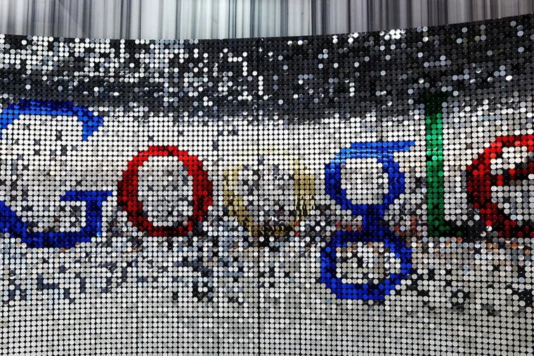 A sign featuring Google Inc.'s logo stands inside the entrance to their U.K. headquarters at Six St Pancras Square in London.