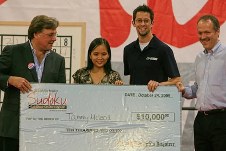 Brian Tierney, publisher of the Philadelphia Inquirer (left) , Morgan Haro from Hudson Entertainment (3rd from left) and Will Shortz, host of the championships, present the winner's check to Tammy McLeod, from Los Angeles, Calif. (Akira Suwa  /   Staff Photographer )