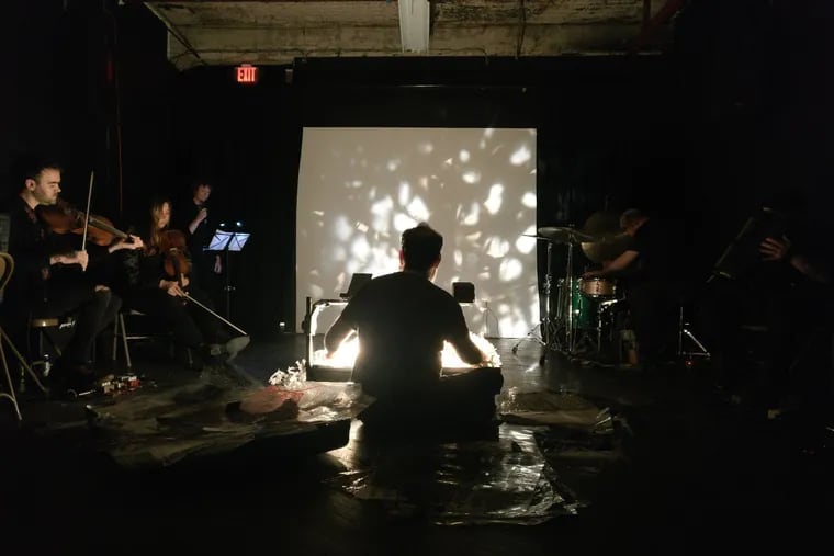 Erik Ruin's Ominous Cloud Ensemble at Vox Populi in 2019. The Ensemble, which combines Ruin’s intricate paper-cut projections with a rotating cast of local improvisers, plays at the Fire Museum fundraiser concert on Friday.