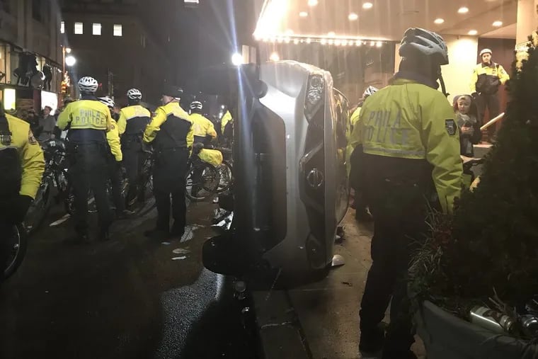 A car was overturned on Walnut Street near Broad during the mass victory celebrations Sunday night after the Eagles’ Super Bowl victory.