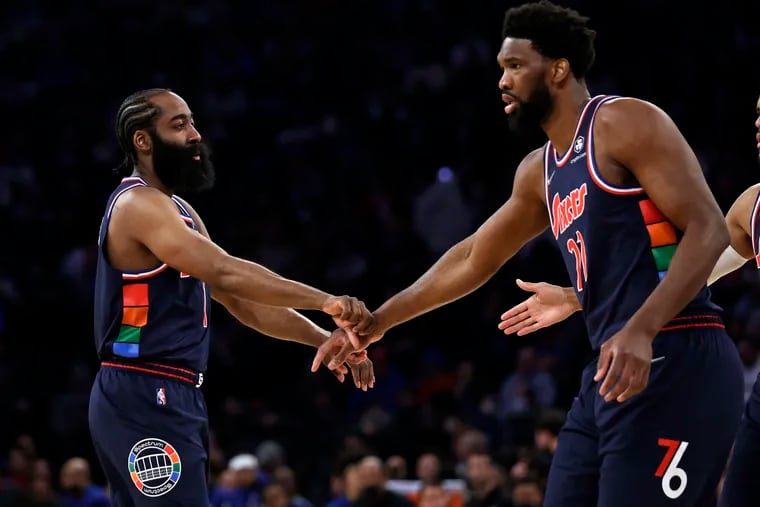 The Sixers' James Harden (left) reacts with Joel Embiid against the New York Knicks on Sunday Madison Square Garden.