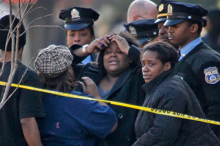 A family reacts to a double shooting on 19th Street on Jan. 25.