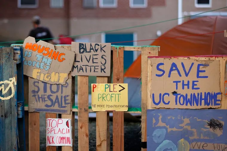 Signs outside of the University City Townhomes, where an encampment and protests began because of the planned sale and redevelopment of the property, on July 21.
