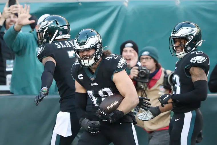 Eagles outside linebacker Alex Singleton (center) celebrates his fourth quarter 29-yard interception runback for a touchdown with teammates cornerback Darius Slay (left) and safety Rodney McLeod against the New York Giants on Sunday, December 26, 2021 in Philadelphia.