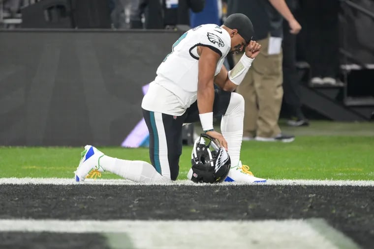 Philadelphia Eagles quarterback Jalen Hurts kneels before the start of the season opener in Brazil. On Wednesday, Frankie Beverly, one of Hurts' favorite artists, passed away.