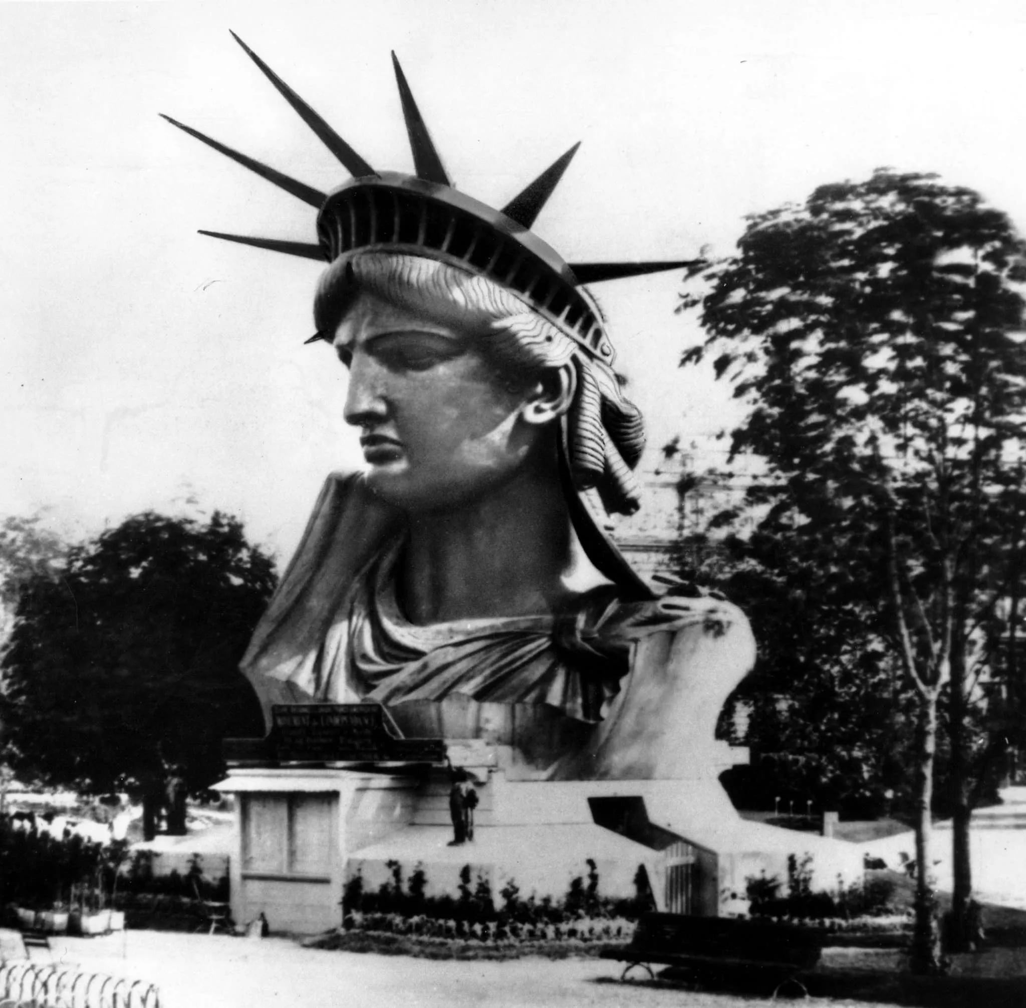 Statue of Liberty's head and shoulders on display at the 1878 World's Fair in Paris. Completion by sculptor Auguste Bartholdi