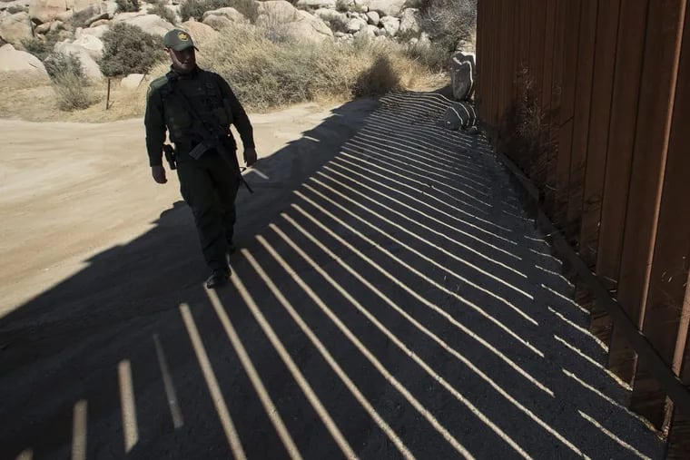 U.S. Border Patrol agent Jason Bush patrols along a massive steel fence on the Mexican border in Jacumba Hot Springs, Calif. (Brian van der Brug/Los Angeles Times/TNS)