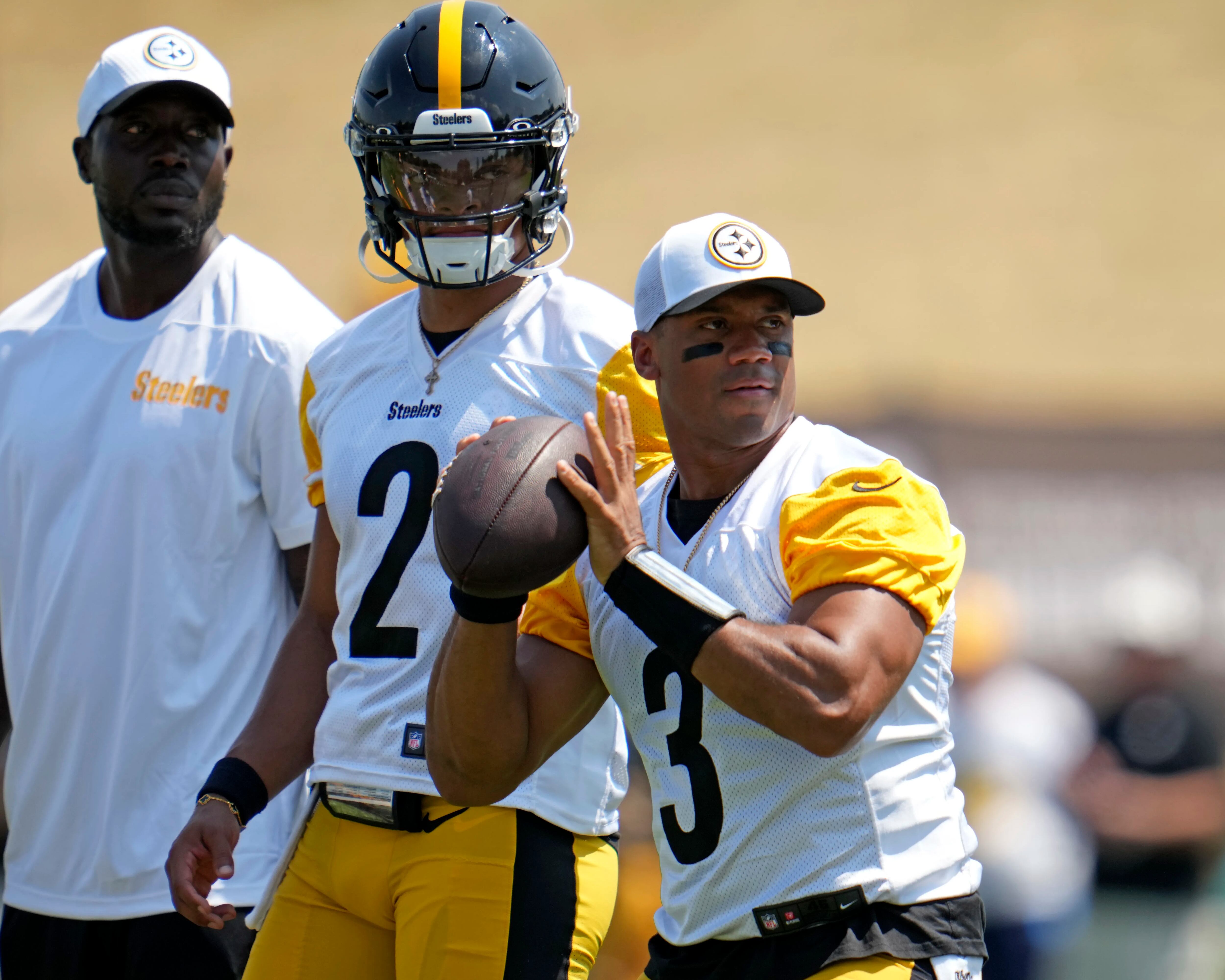 Pittsburgh Steelers quarterbacks Russell Wilson (3) and Justin Fields (2) participate in the NFL football team's training camp in Latrobe, Pa., Sunday, July 28, 2024. (AP Photo/Gene J. Puskar)