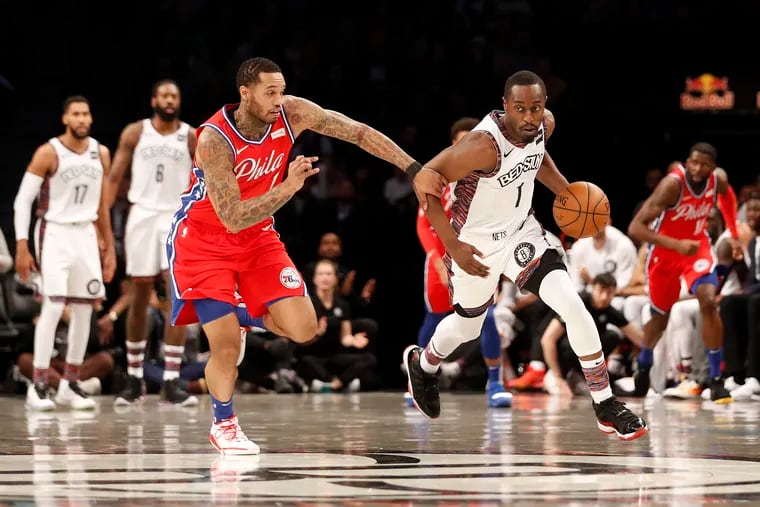 Philadelphia 76ers forward Mike Scott (1) defends against Brooklyn Nets guard Theo Pinson (1) during the first quarter.
