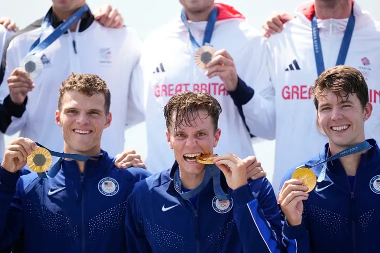 From left, the United States' Michael Grady, Justin Best,  and Nick Mead celebrate gold in the men's fours rowing final.