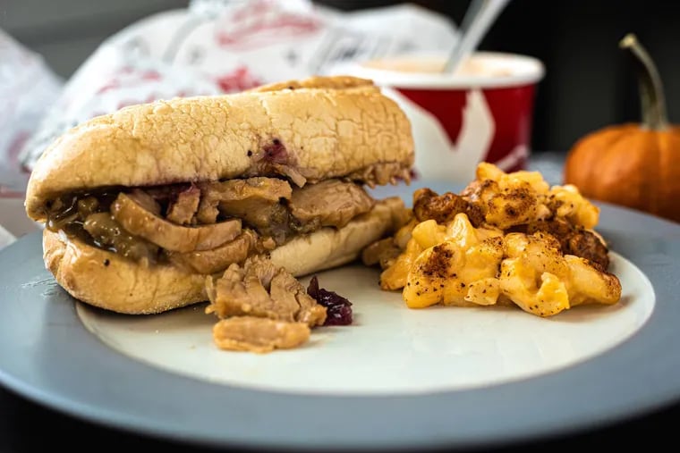 The Gobbler, Wawa's hoagie filled with turkey, stuffing, cranberry sauce, and gravy that been a staple of its fall menu since 2008, is paired here with Wawa mac and cheese garnished with Old Bay seasoning.