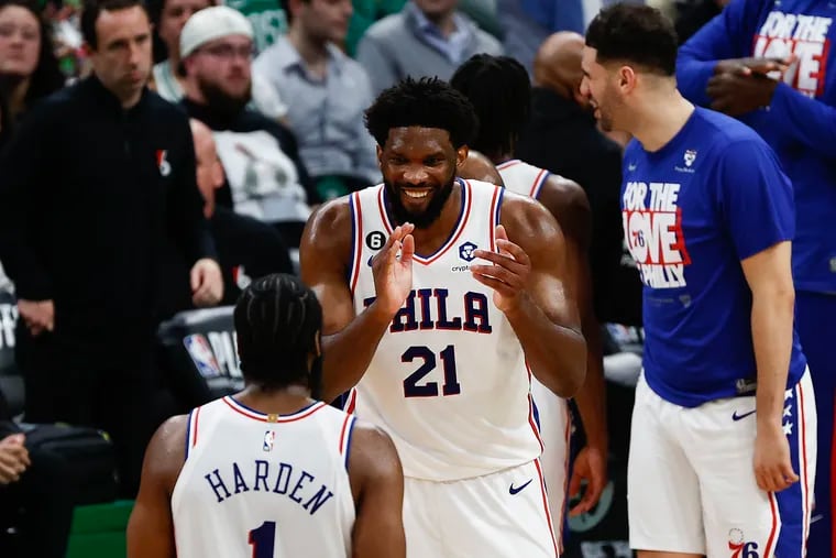 Sixers center Joel Embiid celebrates in the fourth quarter with teammate guard James Harden against the Boston Celtics in Game 5 of the Eastern Conference semifinal playoffs at TD Garden in Boston on Tuesday, May 9, 2023.