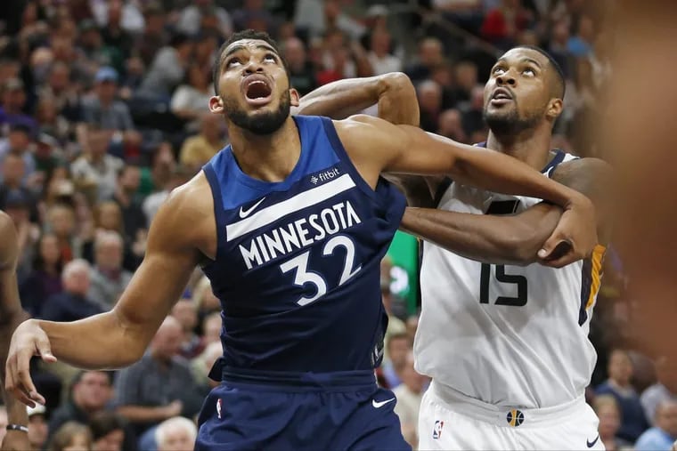 Jazz forward Derrick Favors, here battling for a rebound with Minnesota center Karl-Anthony Towns (32), will draw the defensive assignment on Joel Embiid if the Sixers center plays.