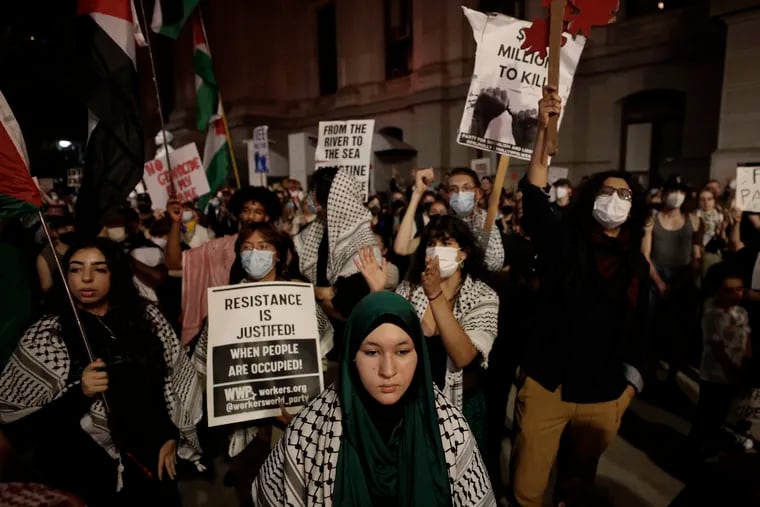 People rally at City Hall calling for a cease-fire between Israel and Hamas on Saturday.