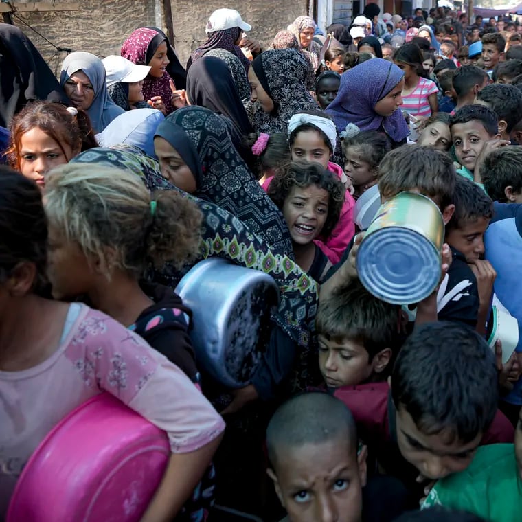 Palestinians line up for food distribution in Deir al-Balah, Gaza Strip, Thursday, Oct. 17, 2024. (AP Photo/Abdel Kareem Hana)