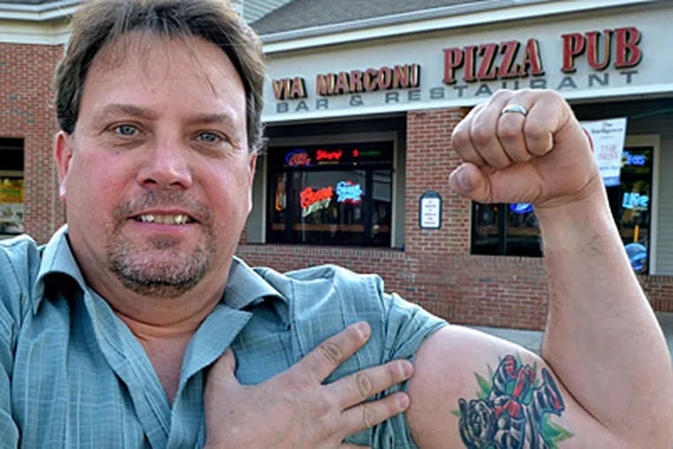 David Morton shows off his Hamburglar tattoo, a reminder of his 90-minute stint behind bars. (P.C. MARX / FOR THE DAILY NEWS)