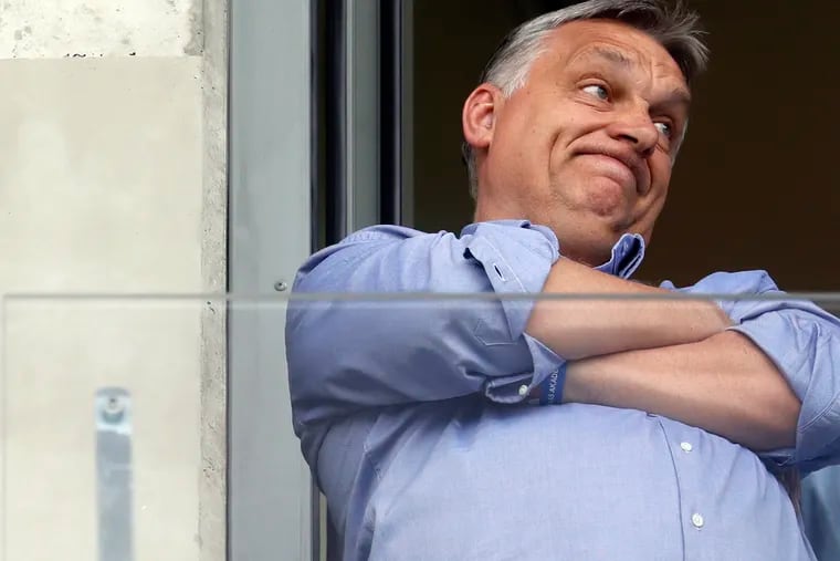 Hungarian Prime Minister Viktor Orban, left, watches a soccer game in his hometown of Felcsut, Hungary May 19, 2019, ahead of the European election on May 26.