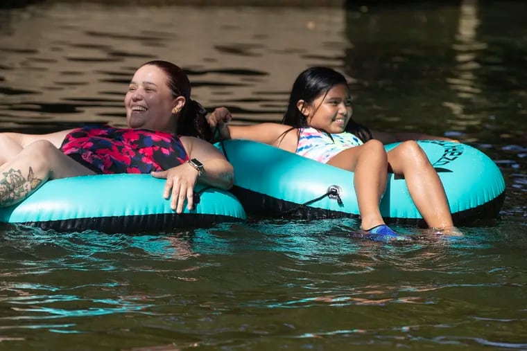 Soledad Navarro and her daugher Natalie cool off tubing in the West Branch of the Brandywine River in at the ChesLen Preserve in Newlin Township, Chester County on July 23, 2022.