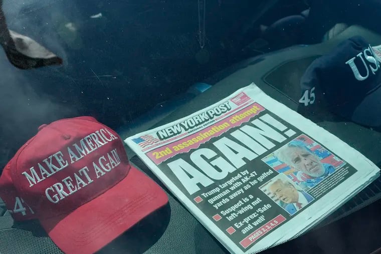 A newspaper is displayed in a vehicle outside of the Mar-a-Lago estate in Palm Beach, Fla., a day after an apparent assassination attempt of Republican presidential nominee and former President Donald Trump on Monday.