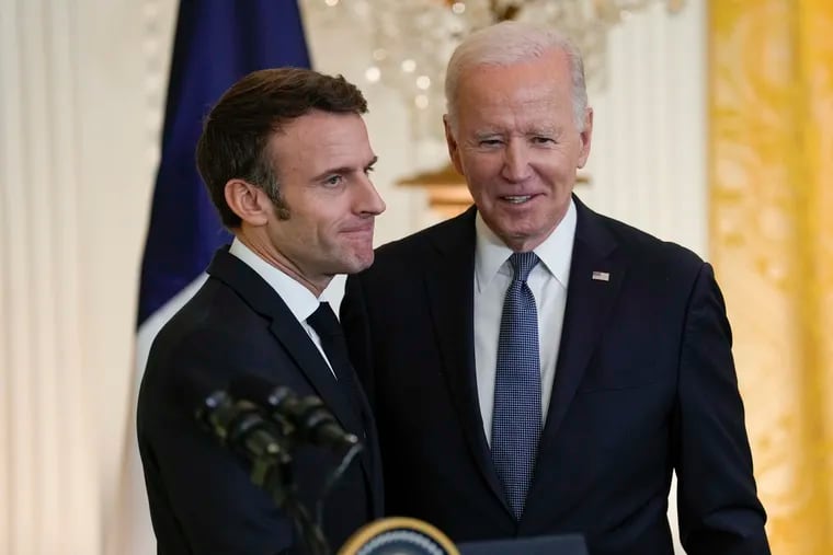 President Joe Biden (right) stands with French President Emmanuel Macron after a Thursday news conference in the East Room of the White House.