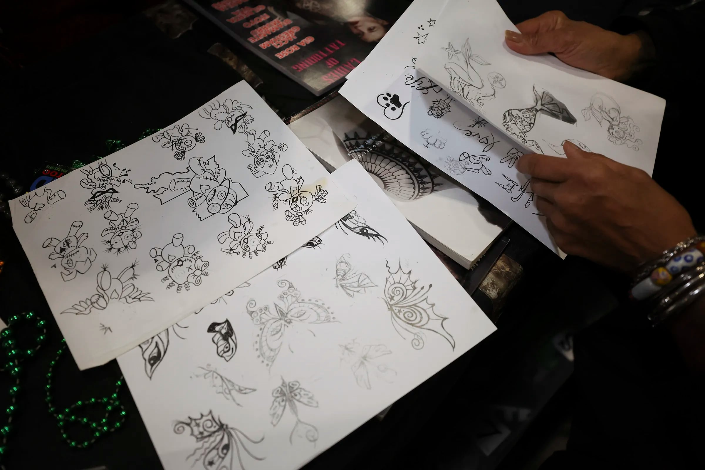 Tattoo artist Jacci Gresham shows her drawings at the Philadelphia Tattoo Arts Festival.