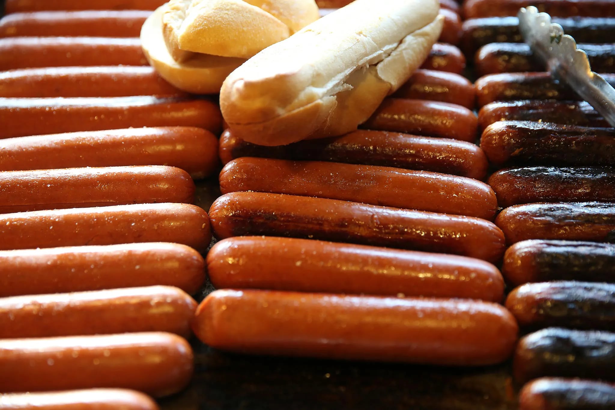 Rows of hot sausage cook on the grill at Johnny's Hots on Delaware Avenue on Feb. 11, 2016, in Philadelphia. ( DAVID MAIALETTI / Staff Photographer )