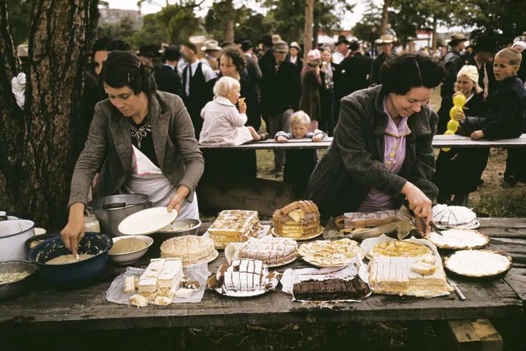 Russell Lee's photograph, "Cutting the pies and cakes at the barbeque dinner, Pie Town, New Mexico Fair,"  at Haverford College's Atrium Gallery