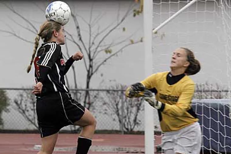 Conestoga goal keeper Meghan Write could not stop Ryan #18 Megan Tole who scores with her heading a ball at 1st half of Archbishop Ryan vs. Conestoga in a Class AAA girls' quarterfinal game. (Akira Suwa / Staff Photographer ).