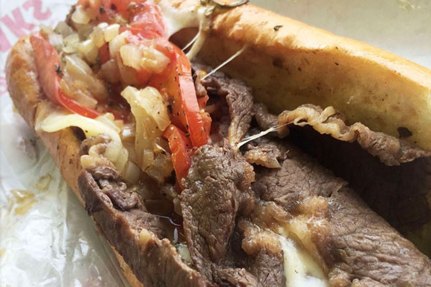Cheesesteak with grilled tomato, onions, provolone, and a long hot from Philip's Steaks (2234 W Passyunk Ave.).