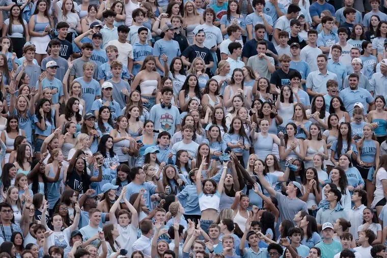 Villanova football fans try to catch t-shirts thrown into the crowd during the Youngstown State at Villanova University football game.