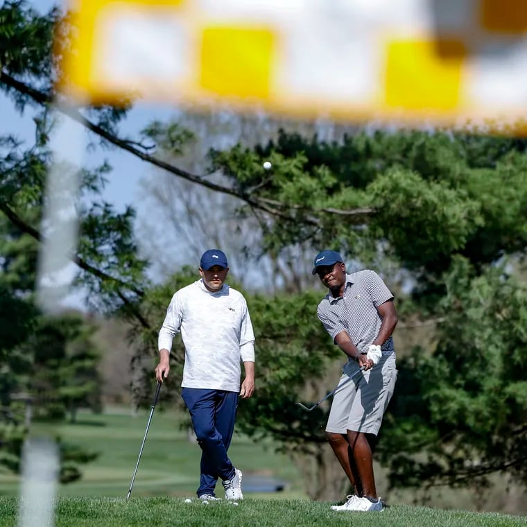 Drexel golf coach Ben Feld, left, works with senior Tafadzwa Nyamukondiwa at the Green Valley Country Club in Lafayette Hill earlier this year.