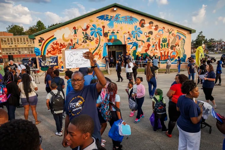 Teacher Hakim Frye shows his eighth-grade students where to line up on the first day of school at F.S. Edmonds Elementary in East Mount Airy.