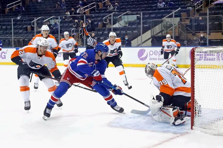 Carter Hart making a save against the New York Rangers' Filip Chytil (72) during the Flyers' 5-4 overtime win Monday at Madison Square Garden.