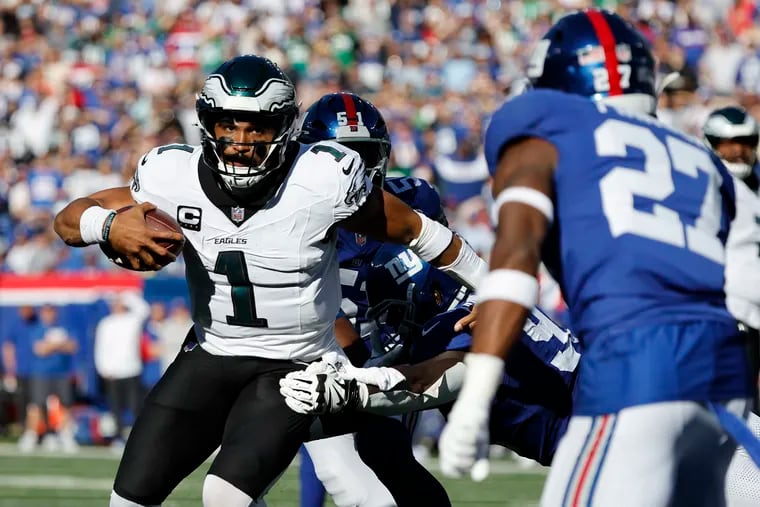 Eagles quarterback Jalen Hurts runs for a first down in the red zone past New York Giants defensive tackle Rakeem Nunez-Roches in the third quarter Sunday.