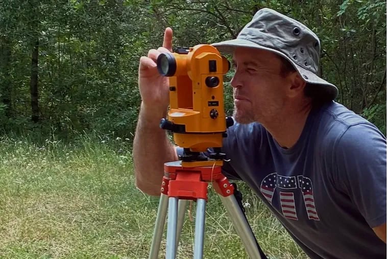 Former Phillies pitcher Brad Lidge, who is pursuing his Ph.D. in archaeology, uses a survey station to set up trench coordinates prior to excavation.