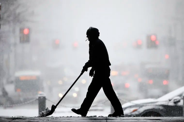 A worker at City Hall shovels snow during a winter storm in Philadelphia, Wednesday, Feb. 20, 2019. The seasonal differences that define life in the Northeast U.S. are beginning to blur under climate change, writes the Franklin Institute's Rachel Valletta.