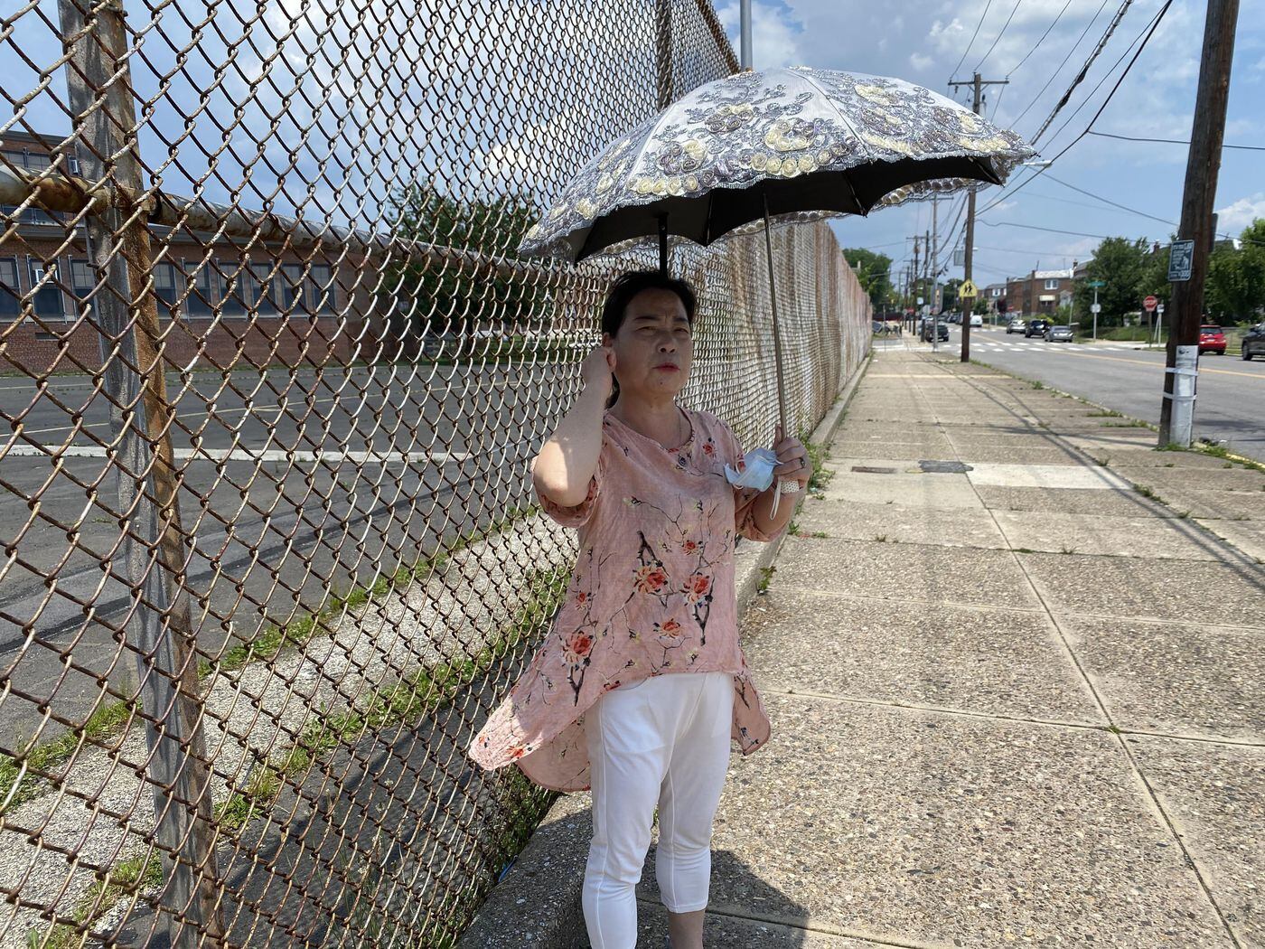 Yue Xian Wu points to her right ear, showing one of the places where her grandson was punched in his head.