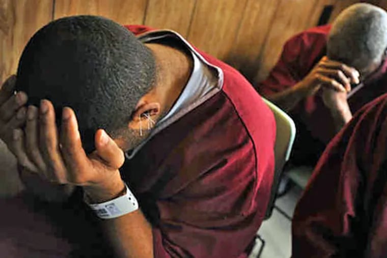 Inmates sit quietly after an acupuncturist has placed superfine stainless-steel needles in the outer ear. Nonviolent offenders are often sentenced to the rigorous 45-day program. (Amy Davis / Baltimore Sun)