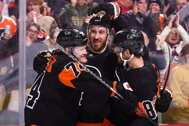 Philadelphia Flyers teammates Owen Tippett (left), Kevin Hayes (center) and Joel Farabee (right) celebrate Farabee's goal against the Florida Panthers on Thursday. (Photo by Tim Nwachukwu/Getty Images)