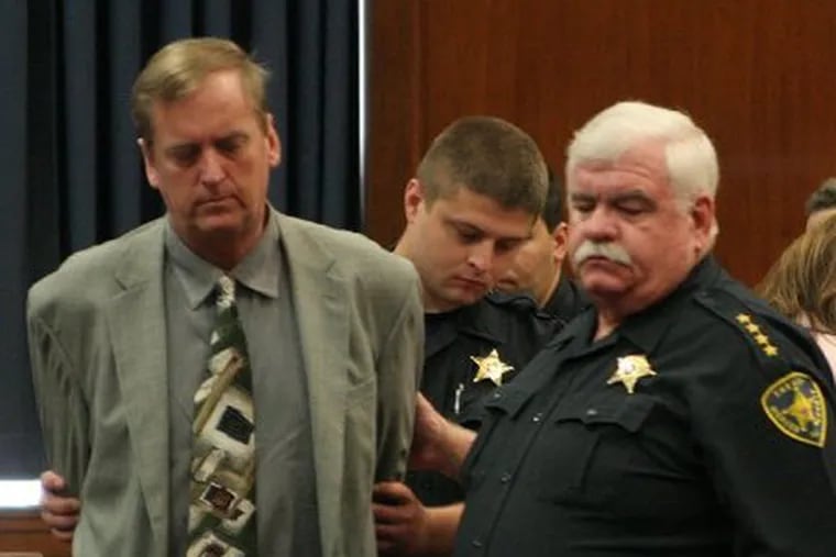 In this 2005 file photo, Jonathan Nyce is led into a courtroom in State Superior Court in Mercer County during his trial for killing his wife, Michelle Rivera Nyce.