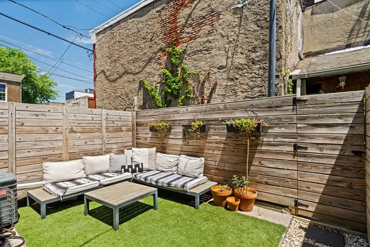 The home has a fenced patio, with ample space for creating garden beds.