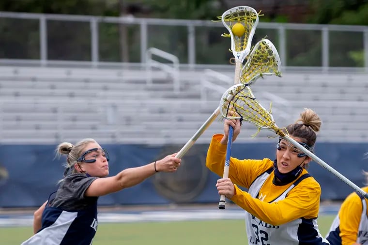 As the Drexel women's lacrosse team prepares for its first-ever NCAA Tournament, Courtney Dietzel (right) takes a shot during a recent practice.