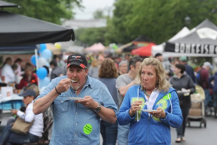 Mike and Donna Hesse of Mount Laurel stroll down Main Street in Evesham during the fifth annual "Taste of Evesham" day. (Clem Murray / Staff Photographer)