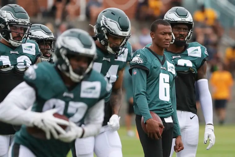 Eagles wide receiver DeVonta Smith (6) watches from the sideline while his teammates run drills during training camp at the NovaCare Complex on Tuesday.