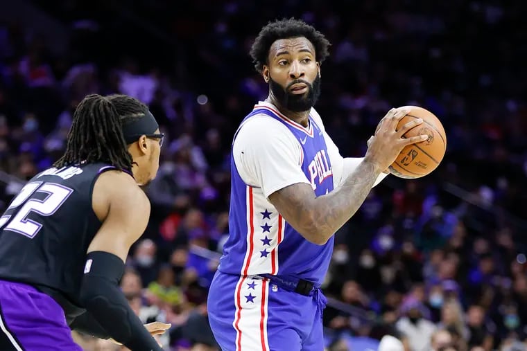 Sixers center Andre Drummond holds the basketball against Sacramento Kings center Richaun Holmes on Saturday, January 29, 2022 in Philadelphia.