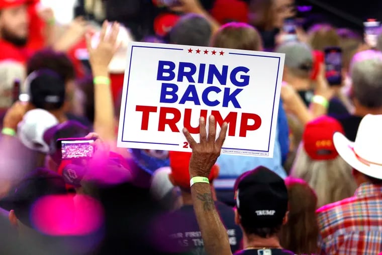 An attendee holds a sign at a campaign rally for Republican presidential nominee former President Donald Trump at the Mohegan Sun Arena at Casey Plaza in Wilkes-Barre, Pa., in August.