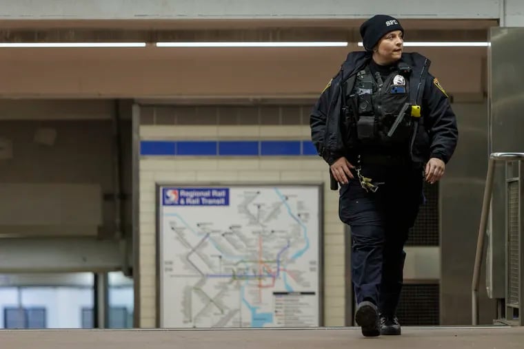 A SEPTA transit police officer at 15th Street Station at 15th and Market Streets in Center City. After increasing patrols, the agency has reported a 45% reduction in serious crimes on the system.